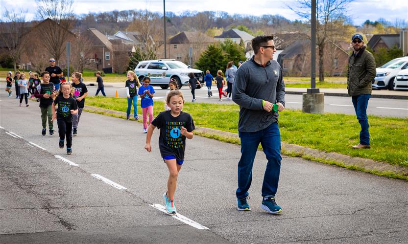 Students run around the track